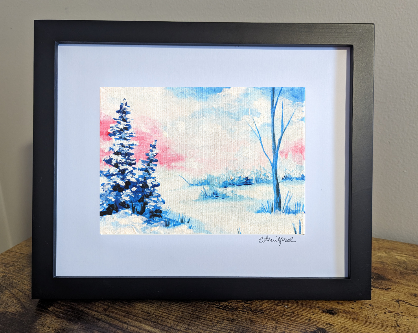 A wintry landscape art print with snow-covered trees and soft pink and blue hues in the sky