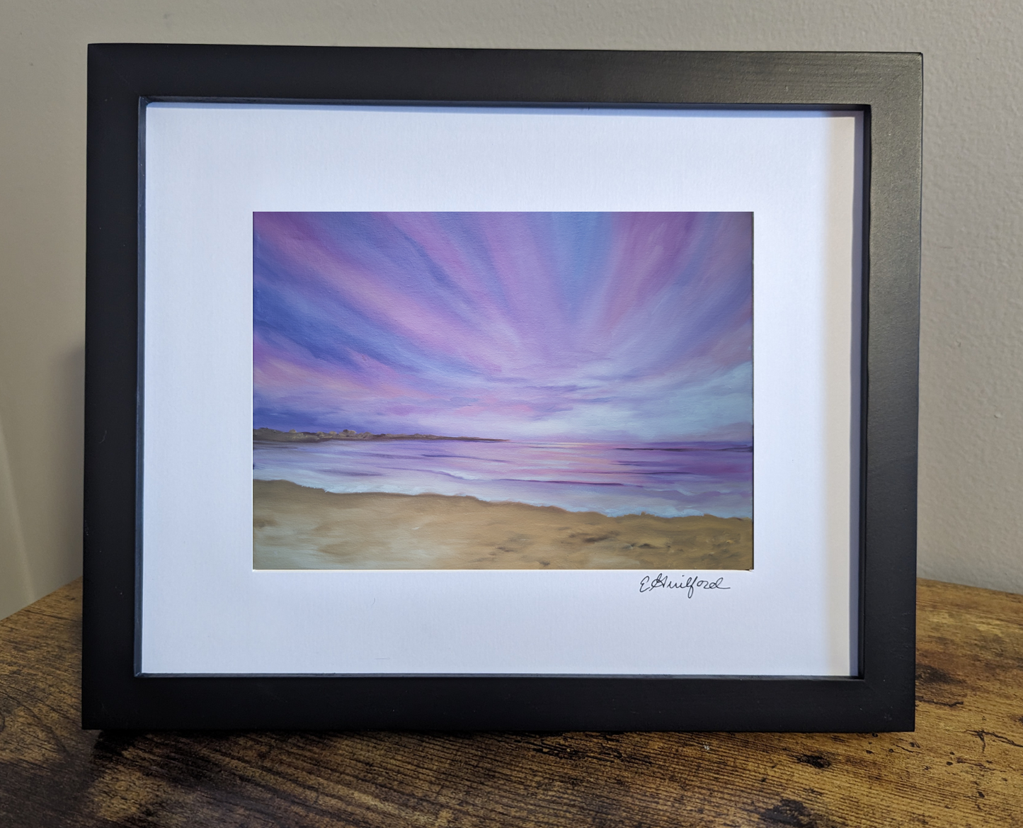 Art print of a beautiful purple sunset over a tranquil beach with soft purple, navy and pink hues in the sky
