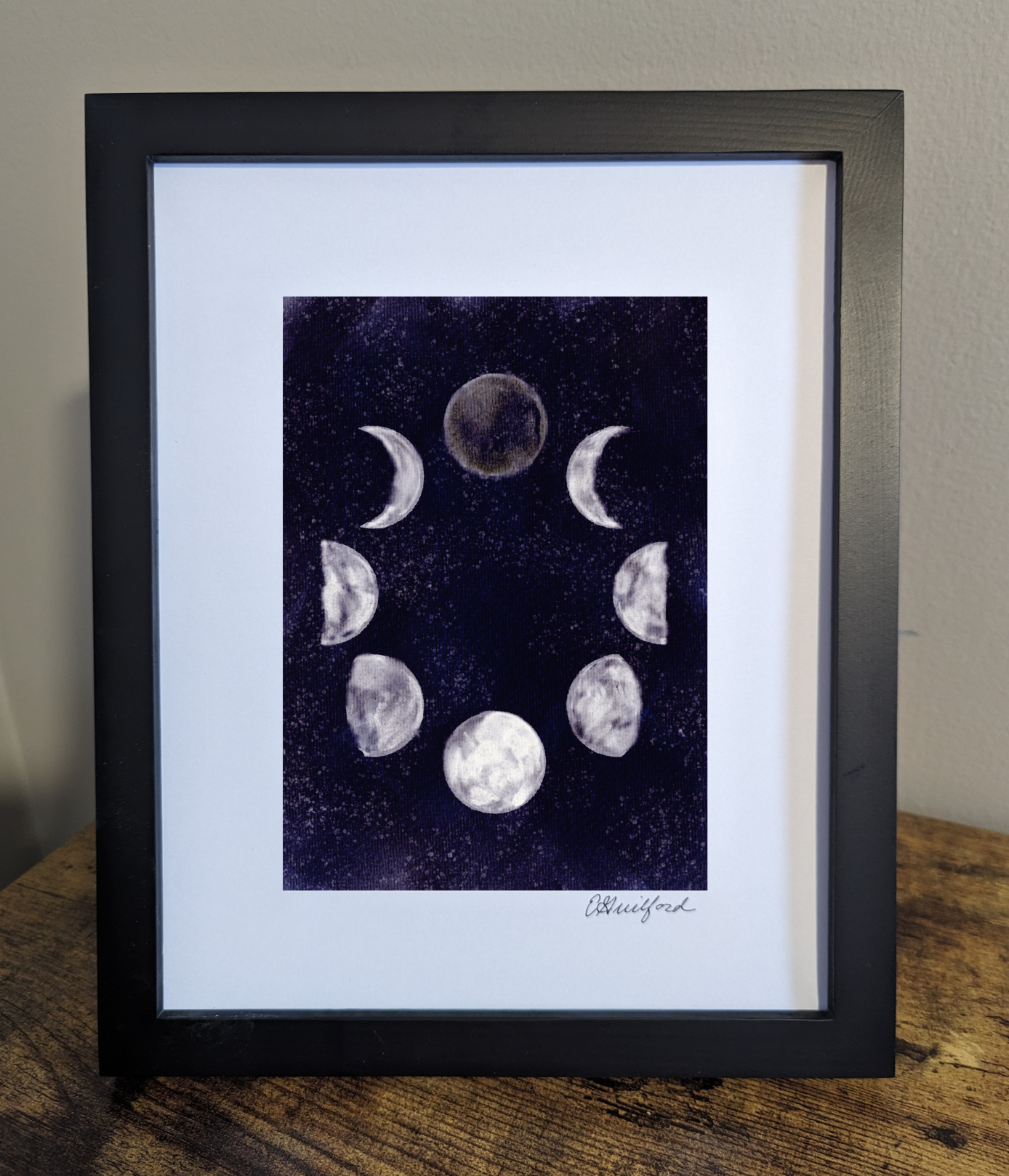 Art print of the moon phases in a circular arrangement against a dark and starry night sky