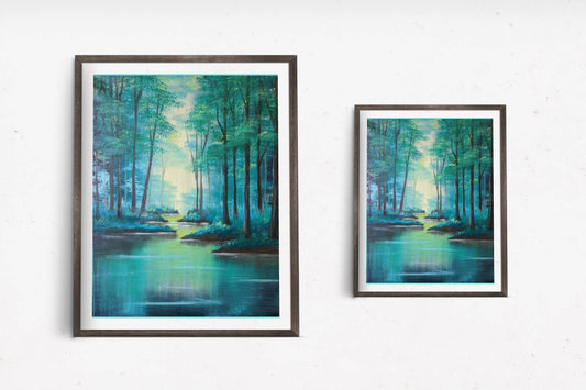 A tranquil framed art print depicting tall trees alongside a calm river illuminated by soft sunlight filtering through the trees