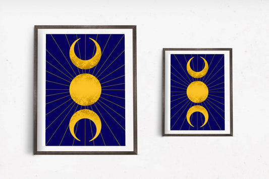 A celestial art print featuring the triple moon symbol, with two crescent moons flanking a full sun all in gold