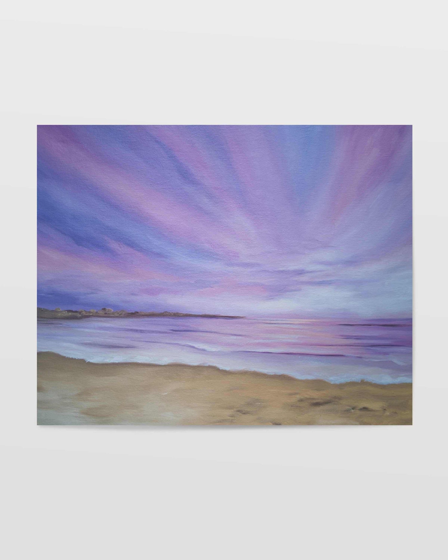 Art print of a beautiful purple sunset over a tranquil beach with soft purple, navy and pink hues in the sky