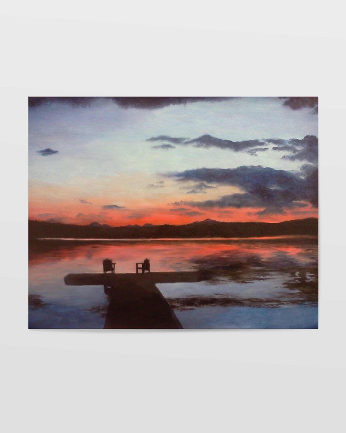 Art print of tranquil sunset scene over a small lake with two chairs placed at the end of a dock