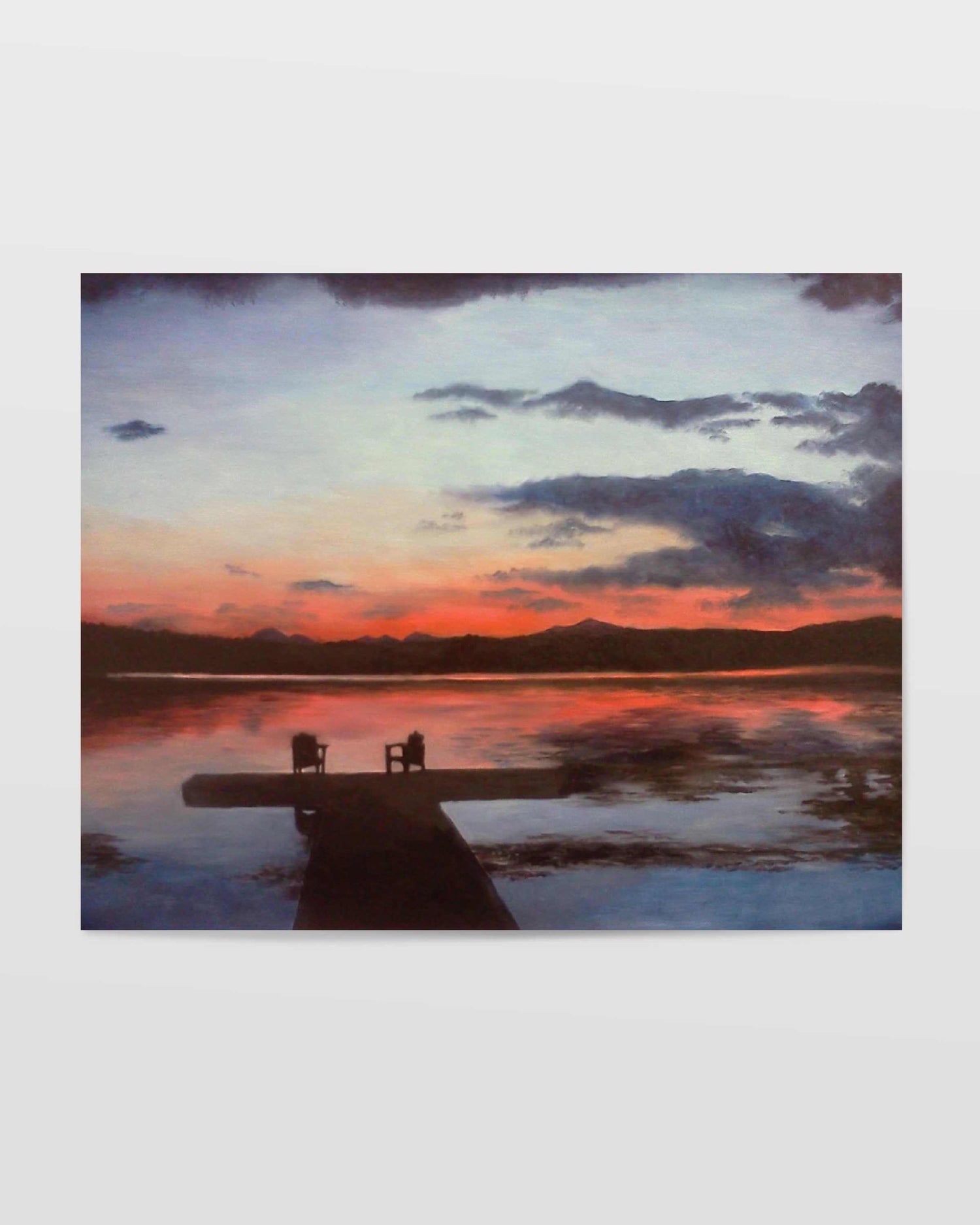 Art print of tranquil sunset scene over a small lake with two chairs placed at the end of a dock