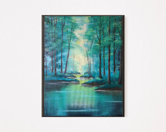 A tranquil framed art print depicting tall trees alongside a calm river illuminated by soft sunlight filtering through the trees