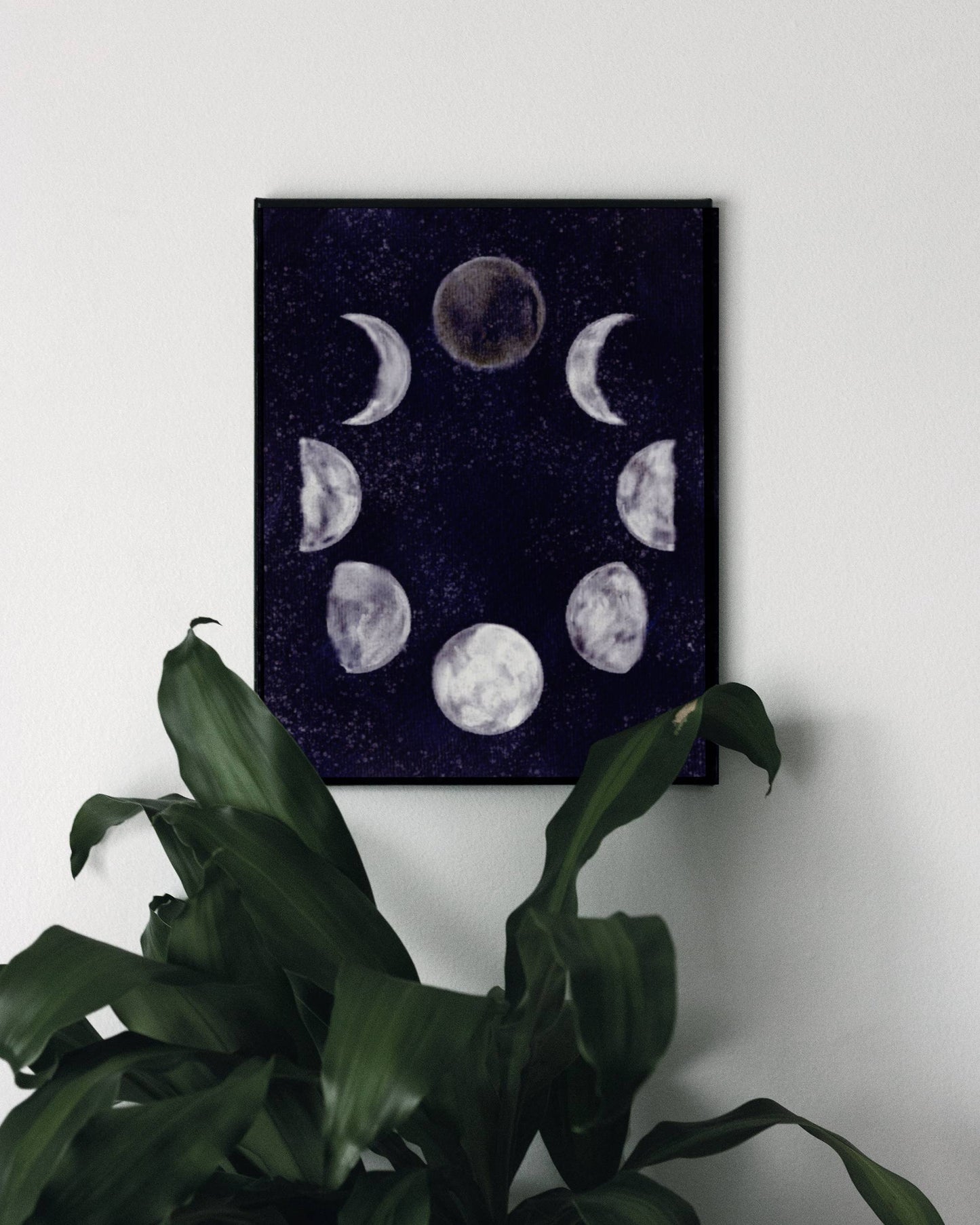 Art print of the moon phases in a circular arrangement against a dark and starry night sky