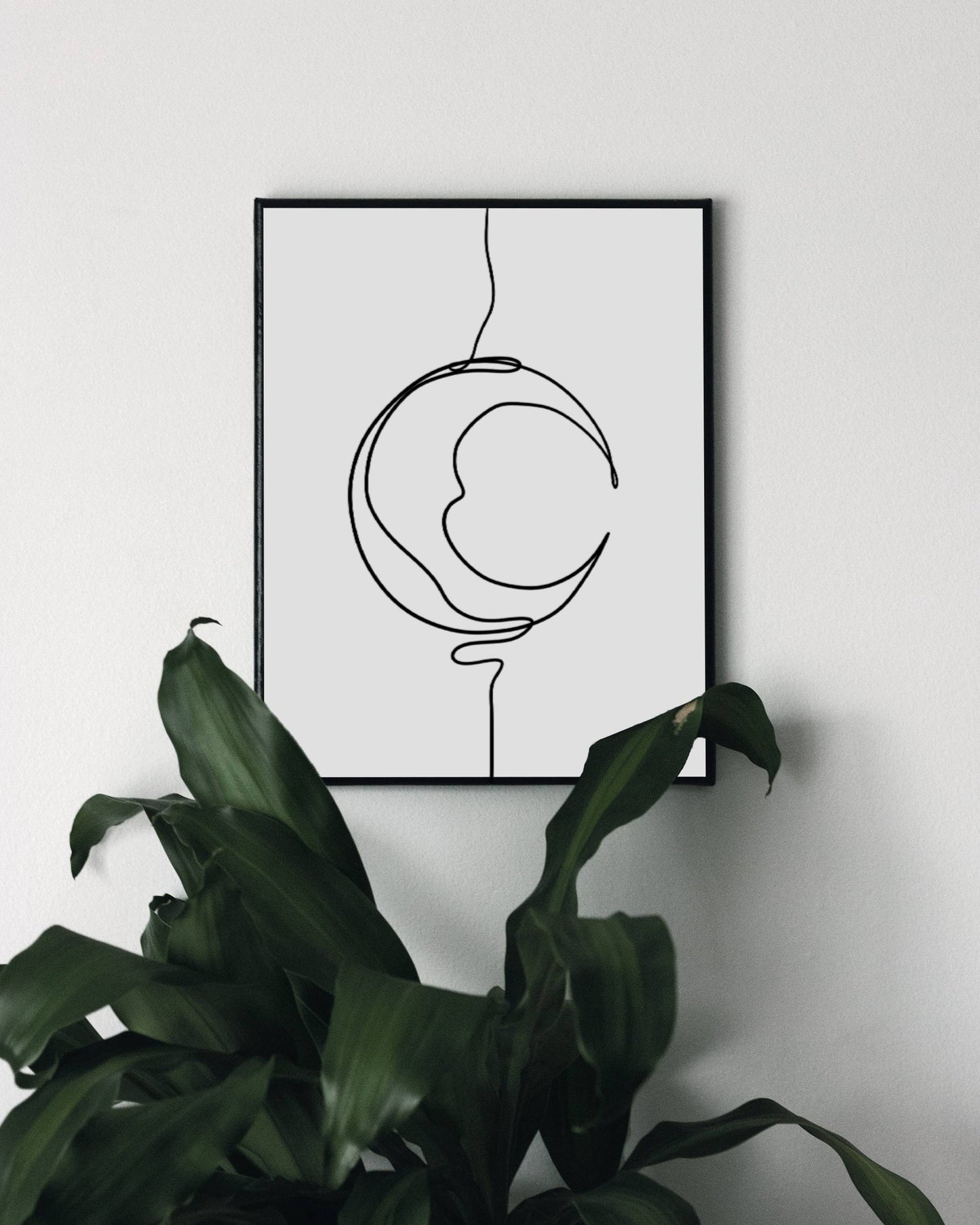 Art print with a minimalist black line drawing of a crescent moon creating an artistic representation of the moon's shape