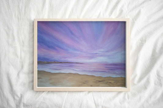 Art print of a beautiful purple sunset over a tranquil beach with soft purple, navy and pink hues in the sky