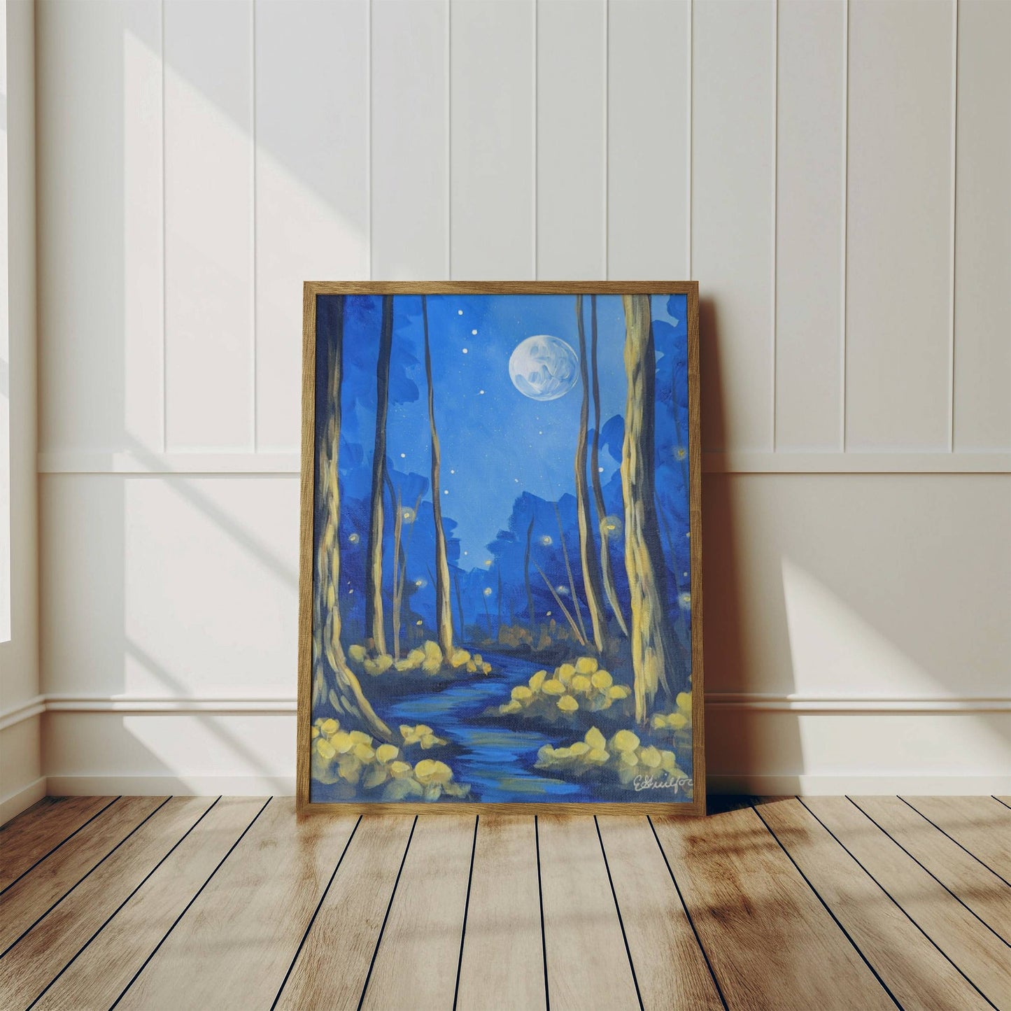 A framed art print of a moonlit dark forest full of fireflies featuring a full moon and trees