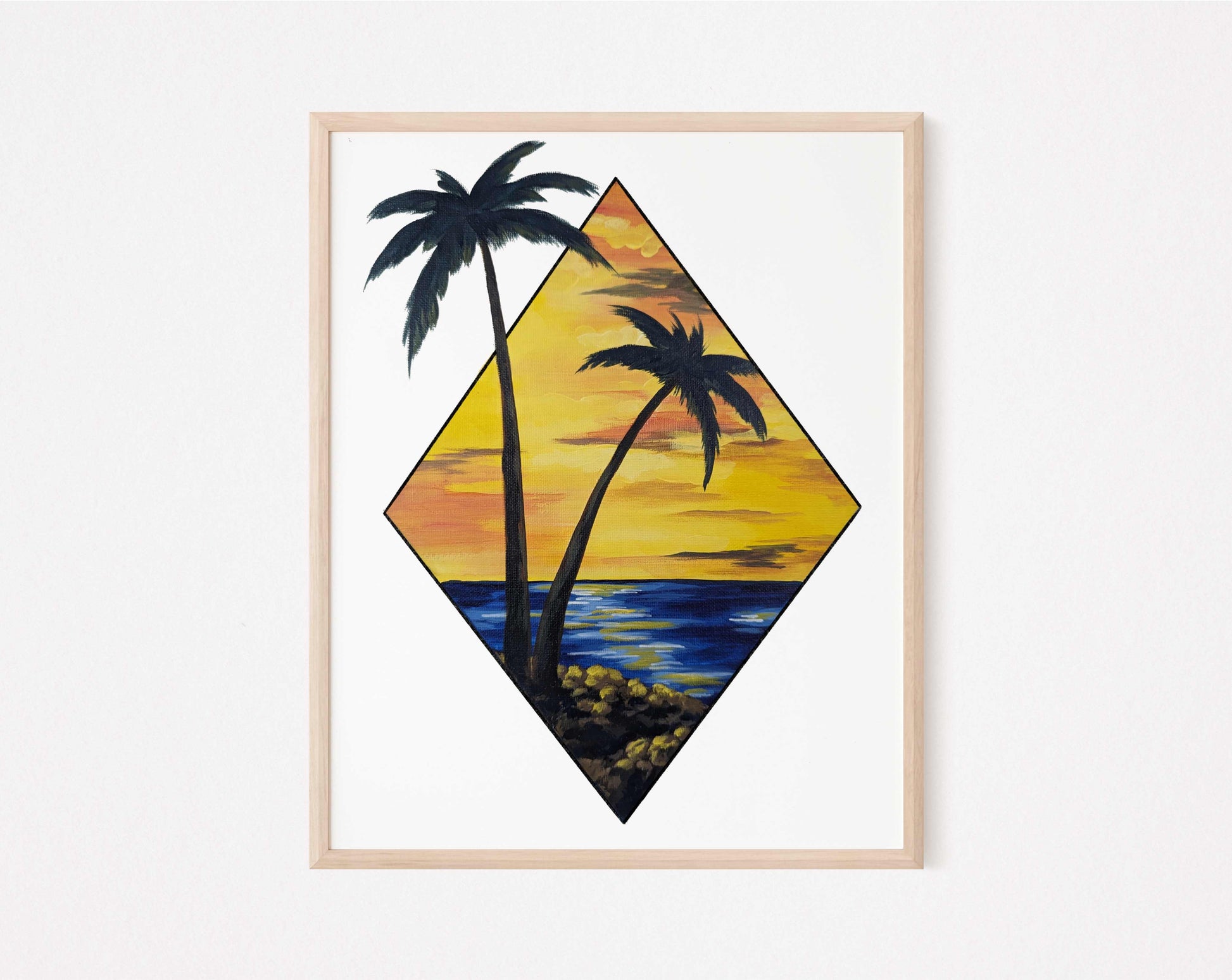 Framed art print featuring a scenic view of two palm trees by the water at sunset