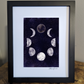 Art print of the moon phases in a circular arrangement against a dark and starry night sky