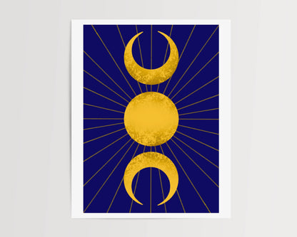 A celestial art print featuring the triple moon symbol, with two crescent moons flanking a full sun all in gold