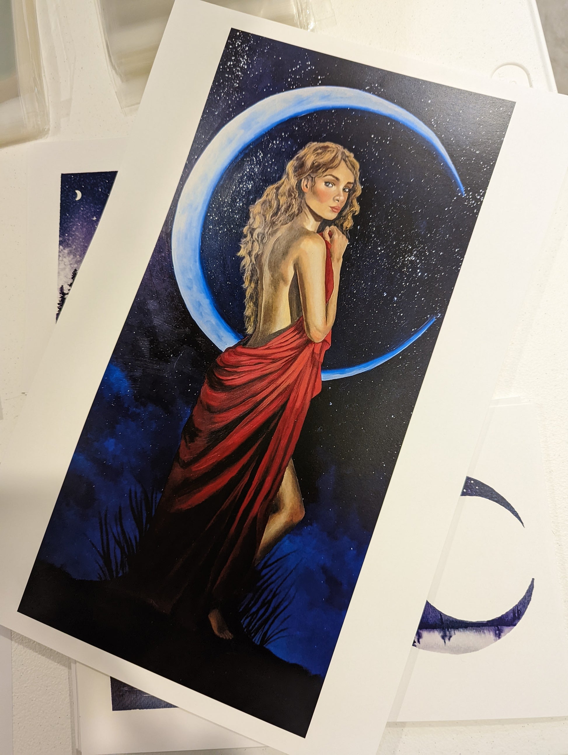 Art print of a moon goddess standing gracefully with a crescent moon behind her wearing a flowing red dress