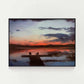 Art print of tranquil sunset scene over a small lake with two chairs placed at the end of a dock