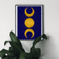 A celestial art print featuring the triple moon symbol, with two crescent moons flanking a full sun all in gold