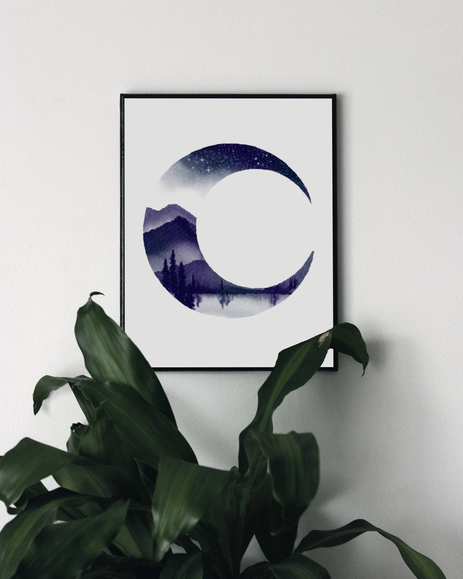 Art print of the crescent moon with a mountainous landscape, a lake, and pine trees filling the crescent shape