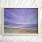 Art print of a beautiful purple sunset over a tranquil beach with soft purple, navy and pink hues in the sky